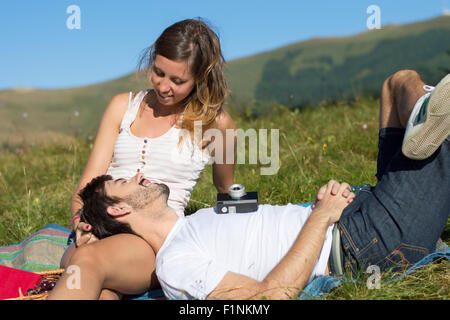 Loving couple out in the field expressing feelings. Outdoors date Stock Photo