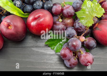 Various summer fruit on the dark wooden table. Healthy fruit background Stock Photo