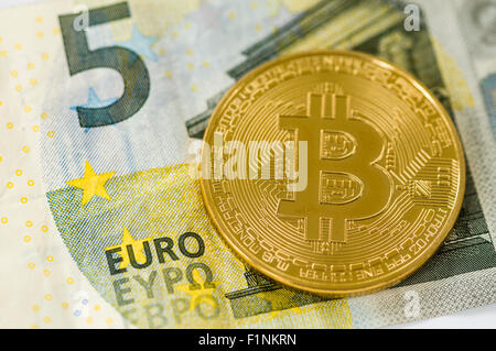 Bitcoin on a €5 five Euro banknote Stock Photo