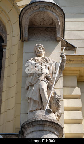 Saint John the Evangelist on the portal of Saint James church in Ljubljana, Slovenia Stock Photo