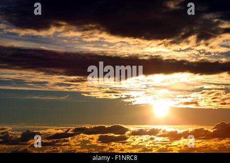 Dramatic sunrise in cloudy sky. Stock Photo