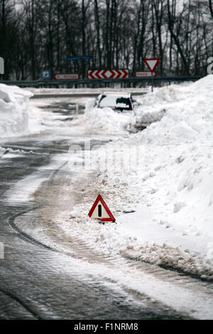 Warning triangle on winter road. Stock Photo