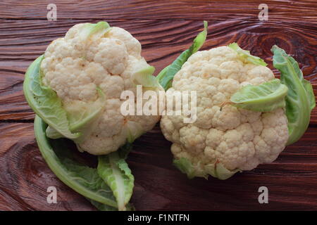 lie on a wooden board Two Cauliflower Stock Photo