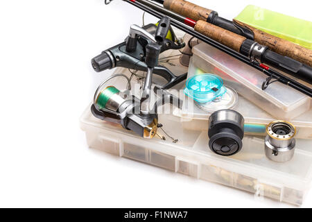 different fishing tackles - rod, reel, line and lures in box on white background Stock Photo
