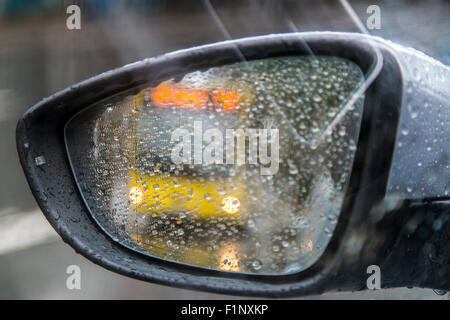 Wet street with cars headlights reflections over pavement in a Stock