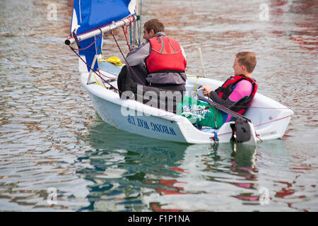 Weymouth, Dorset, UK. 5 September 2015. Crowds attend the Waterfest festival in Weymouth. Sailing dinghy demonstration by Weymouth Sailing Club - Wrong way Up! Credit:  Carolyn Jenkins/Alamy Live News Stock Photo