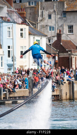 Weymouth, Dorset, UK. 5 September 2015. Crowds attend the Waterfest festival in Weymouth. Crowds are thrilled as Aquatics Jetpacks put on a hoverboarding demonstration in the harbour to show their skills on a hoverboard - a first for Weymouth Credit:  Carolyn Jenkins/Alamy Live News Stock Photo