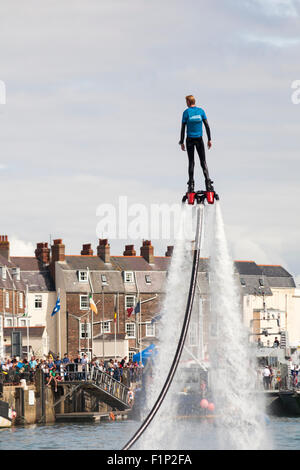 Weymouth, Dorset, UK. 5 September 2015. Crowds attend the Waterfest festival in Weymouth. Crowds are thrilled as Aquatics Jetpacks put on a flyboarding demonstration in the harbour to show their skills on a flyboard Credit:  Carolyn Jenkins/Alamy Live News Stock Photo