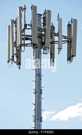 Modern Cellular Tower - Communication Tower on Blue Sky. Vertical Photography. Stock Photo