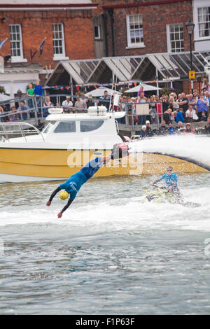 Weymouth, Dorset, UK. 5 September 2015. Crowds attend the Waterfest festival in Weymouth. Crowds are thrilled as Aquatics Jetpacks put on a flyboarding demonstration in the harbour to show their skills on a flyboard - diving like a dolphin Credit:  Carolyn Jenkins/Alamy Live News Stock Photo