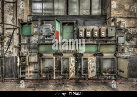 Decayed electrical power cabinets in an abandoned factory Stock Photo