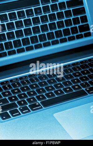 Blue Laptop Technology. Laptop Computer Closeup - Mirroring Keyboard in the Screen. Vertical Photo. Stock Photo