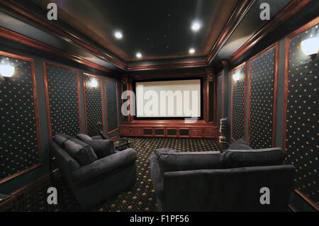 Home Theatre. After Basement Remodeling. Projector Screen and Nice Seats. Elegant Home Theatre Basement Stock Photo