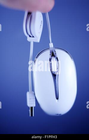 White Wired PC Mouse with USB Cable. Dark Blue Background. Stock Photo