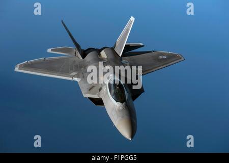 A U.S. Air Force F-22 Raptor from the 95th Fighter Squadron, Tyndall Air Force Base, Fla., flies over the Baltic Sea Sept. 4, 2015. The U.S. Air Force has deployed four F-22 Raptors, one C-17 Globemaster III, approximately 60 Airmen and associated equipment to Spangdahlem Air Base, Germany. While these aircraft and Airmen are in Europe, they will conduct air training with other Europe-based aircraft. Stock Photo