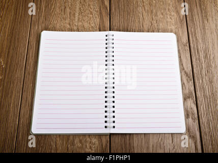 Notebook paper. Blank white page over wooden  background Stock Photo