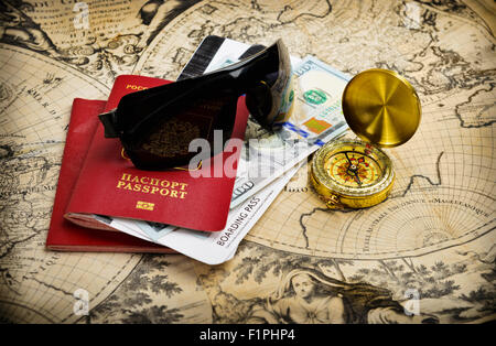 World travel concept. Passport and journey items on vintage world map Stock Photo