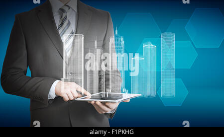 Businessman using tablet with 3d model of city Stock Photo