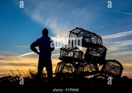 Saturday 5th September 2015, Redcar, north east England, United Kingdom. Weather: photographer at sunset near lobster pots at Paddy`s Hole near Redcar as Saturday ends with a glorious sunset on the north east coast. Stock Photo