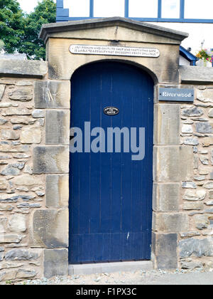 Blue door with request to shut the gate UK Stock Photo