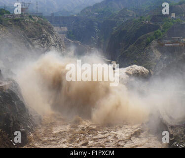 Linxia, China's Gansu Province. 6th Sep, 2015. Water gushes out from the sluicing sediment hole of Taohekou in Liujiaxia Reservoir on the Yellow River, northwest China's Gansu Province, Sept. 6, 2015. The rock plug of the sluicing sediment hole of Taohekou is demolished successfully on Sunday. Credit:  Shi Youdong/Xinhua/Alamy Live News Stock Photo