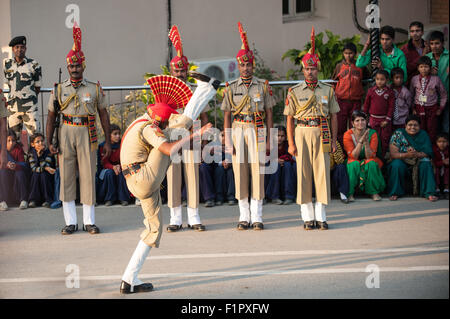 Amritsar, Punjab, India. Indian soldier high kick march during the ceremony of closing the gates at the India Parkistan border. Stock Photo