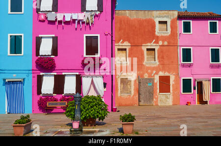 Brightly painted houses in pretty square Burano Venetian Lagoon Veneto Italy Europe Stock Photo