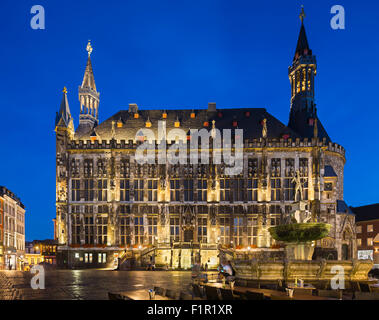 The historic town hall of Aachen, Germany with night blue sky and the Karlsbrunnen in the foreground. Taken with a shift lens. Stock Photo