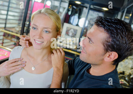 Man offering his girlfriend some jewellery Stock Photo