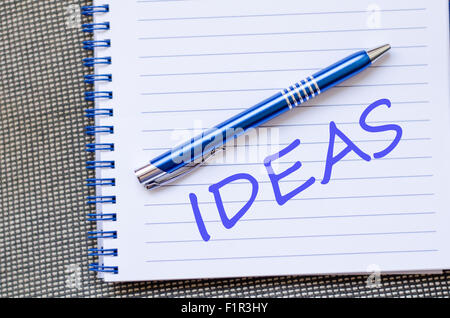 Notepad and pen on wooden background and text concept Stock Photo