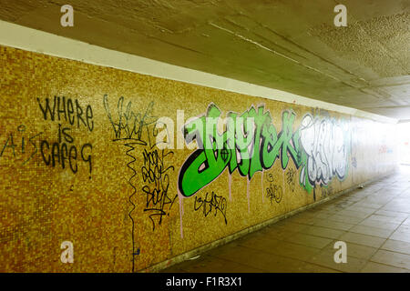 graffiti tags in underground empty walkway Birmingham UK Stock Photo