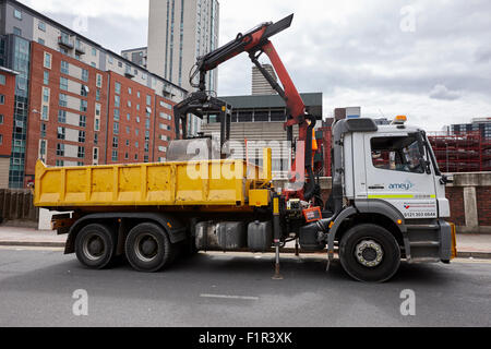 lorry unloading building materials at the roadside in city centre Birmingham UK Stock Photo