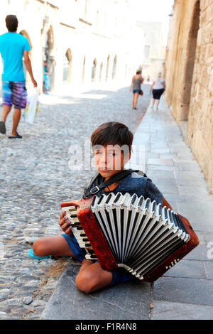 Seven year old Dmitri busking in Street of the Knights Rhodes Stock Photo