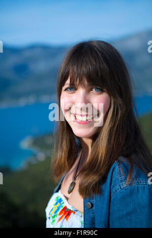 An attractive young Caucasian brunette woman smiling Stock Photo