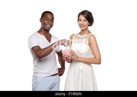 Three Quarter Shot of a Young Couple with Piggy Bank Smiling at the Camera isolated on white Stock Photo