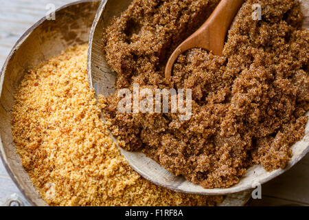 soft brown dark sugar and unrefined sugar cane in bowls Stock Photo