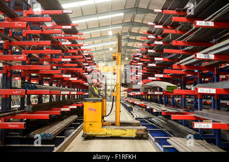 Steel warehouse racking side loading forklift Stock Photo