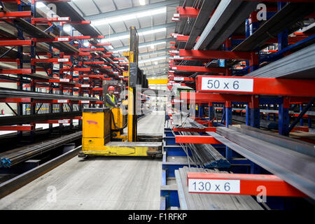 Steel warehouse racking side loading forklift Stock Photo