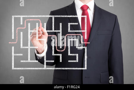 Businessman finding the solution of a maze Stock Photo
