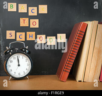 Back to school background with books and alarm clock Stock Photo - Alamy