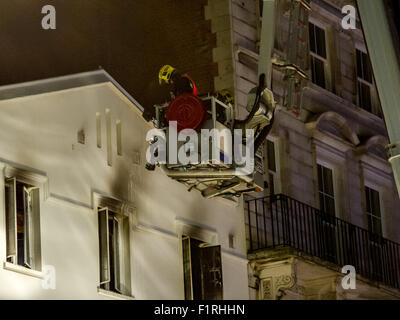 London, UK. 06 September, 2015. 35 Firefighters tackling a fire at the Lyceum Tavern on the Strand. Six fire engines from Soho, Lambeth and Euston attended. 50 people left the building including flats above the pub thanks to a smoke alarm. The third floor and the loft were damaged in the blaze. Credit:  Pete Maclaine/Alamy Live News Stock Photo