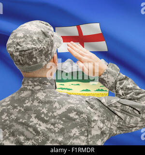 Soldier saluting to Canadial province flag conceptual series -  - Alberta Stock Photo