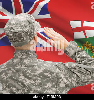 Soldier saluting to Canadial province flag conceptual series - Ontario Stock Photo