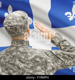 Soldier saluting to Canadial province flag conceptual series - Quebec Stock Photo