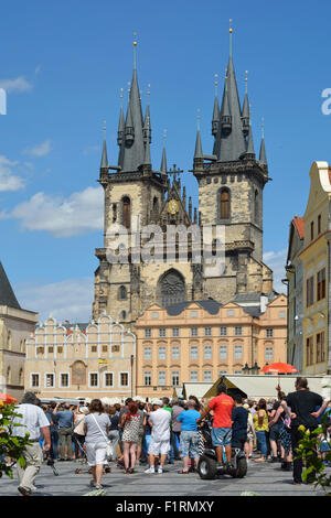 Tourists at the Old Town Square in front of the Church of Our Lady before Tyn of Prague. Stock Photo