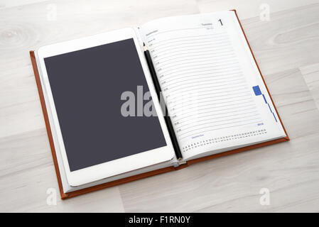 Digital tablet with blank white screen and coffee cup Stock Photo