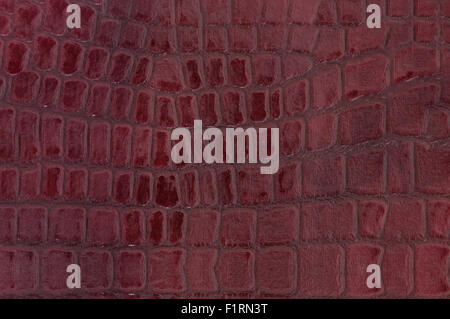 Dark red colored crocodile leather texture as abstract background Stock Photo