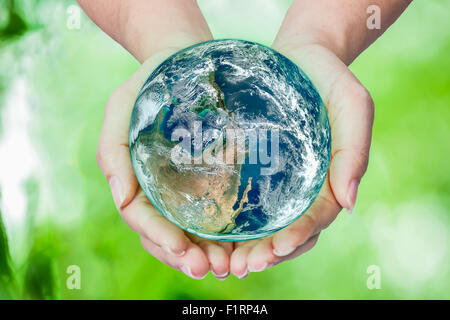 Woman holding globe on her hands, Elements of this image furnished by NASA Stock Photo