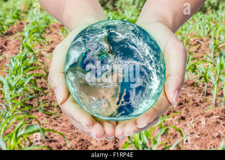 Woman holding globe on her hands, Elements of this image furnished by NASA Stock Photo