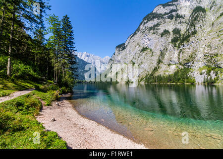 Beautiful landscape of alpine lake with crystal clear green water and mountains in background, Obersee, Germany Stock Photo